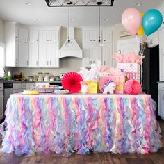 a table covered with colorful streamers and balloons