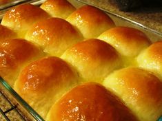 bread rolls in a glass baking dish on a rack