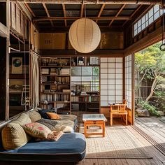 a living room filled with furniture and bookshelves next to a wooden floor covered in windows