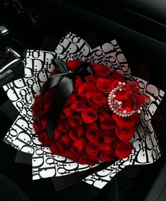 a bouquet of red roses in the center of a car