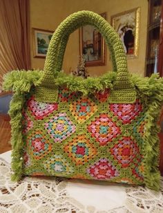 a crocheted purse sitting on top of a table