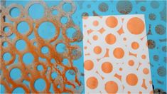 an orange and white paper with circles on it next to a blue background that has holes in it