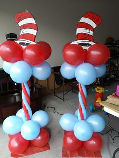 two red, white and blue balloons with the cat in the hat hats on them