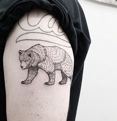 a bear tattoo on the left upper arm