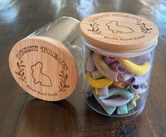 a jar filled with rubber bands sitting on top of a wooden table