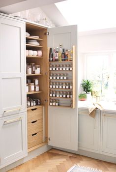 an open cabinet in the corner of a kitchen