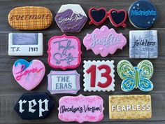 decorated cookies are arranged on a table with the names and numbers in different colors, shapes and sizes