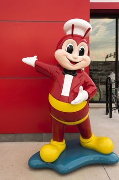 mickey mouse mascot standing in front of a building