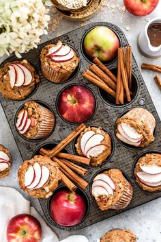 muffins with apples and cinnamon sticks in a muffin tin