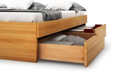 a bed with two drawers underneath it