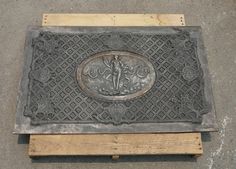 a manhole cover sitting on top of a wooden pallet