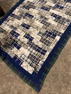 a blue and white quilt is laying on the floor