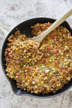 a skillet filled with ground beef and vegetables