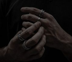 two hands holding each other with rings on their fingers