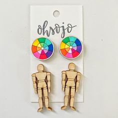 pair of wooden toy figures with colorful umbrella