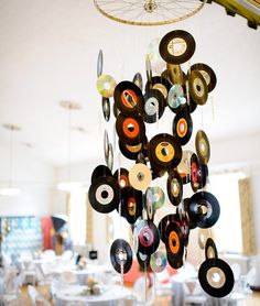 a wind chime hanging from the ceiling in a room filled with tables and chairs