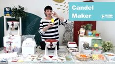 a woman standing in front of a table filled with candy making supplies and candies