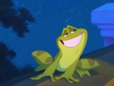 a frog that is sitting down with the caption prince naveen even as frog he's still smiling