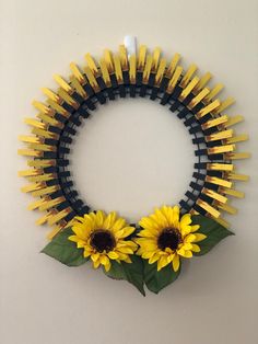 a yellow and black wreath with two sunflowers