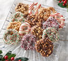 a glass platter filled with assorted pretzels and candy caned treats