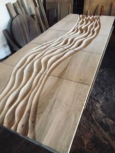 a wooden table with wavy lines carved into it