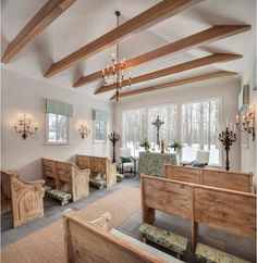 the interior of a church with wooden pews and chandelier hanging from the ceiling