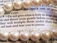 a close up of some pearls on top of a piece of paper with words written in it