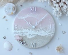 a clock that is sitting on a table with shells and seashells around it