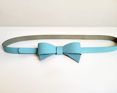 This beautiful and original belt is made of sky blue firm natural leather. The leather bow on the front will perfectly accentuate your waist and highlight your personal style. The belt will look great on dresses and skirts. Belt closes with metal snap, which is hidden under leather bow- put belt tail through the loop and close it. The belt has three holes to adjust  your waist.  The size chart shows the waist circumference from the first hole to the third hole. Main colour: blue Material: Natura Sky Blue Colour, Bow Belt, Leather Bow, Leather Bows, Suspender Belt, Waist Circumference, Blue Colour, Main Colors, Suspenders