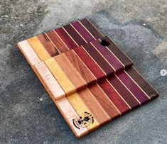 a wooden cutting board sitting on the ground