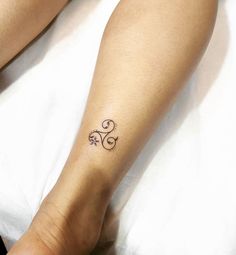 a woman's foot with a tattoo on the left side of her right leg