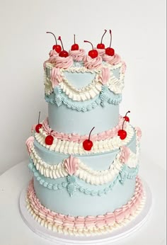 a three tiered cake with cherries on top