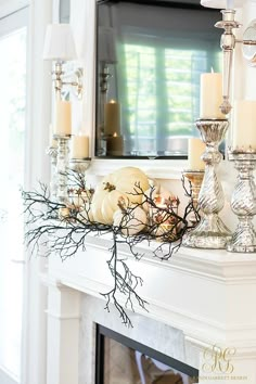 an instagram page with candles and pumpkins on the mantle in front of a mirror