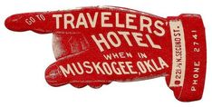 a red and white sign that says travelers hotel when in muskegee, alaska