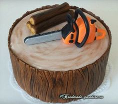 there is a cake that has been decorated to look like a tree stump with a saw and pliers on it