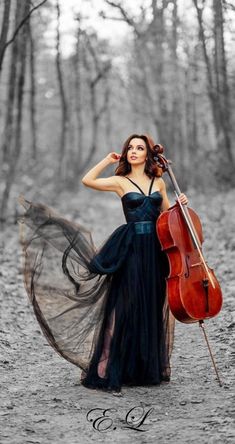 a woman in a black dress holding a cello