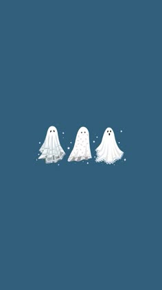 three ghost like creatures standing in the middle of a blue background with snow flakes