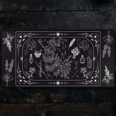 a black and white placemat with flowers, plants and other things on the table