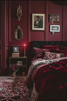 a bedroom with red walls and pictures on the wall