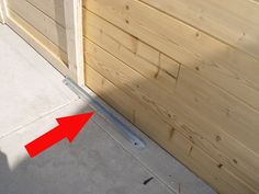 an arrow pointing to the side of a wooden garage door