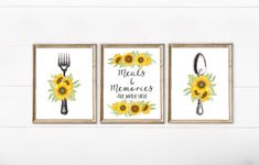 three sunflowers and forks are hanging on the wall