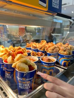 a display case filled with lots of different types of food on top of metal trays