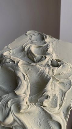 a close up of a cake with white frosting on it's edges and swirls