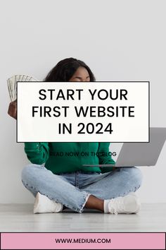 a woman sitting on the floor with her laptop and money in front of her