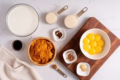 ingredients to make pumpkin pie laid out on a cutting board