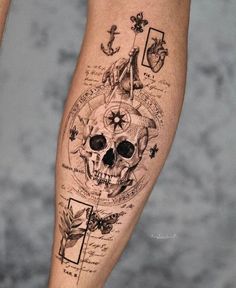 a person with a tattoo on their leg has a skull and compasss in it