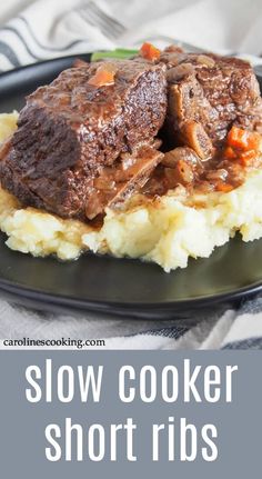 a black plate topped with mashed potatoes and beef