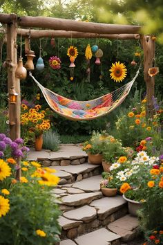 a hammock hanging from a wooden structure in a garden filled with flowers and plants