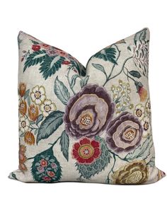 an embroidered pillow with flowers on it