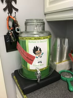 a glass jar sitting on top of a counter next to some scissors and other items